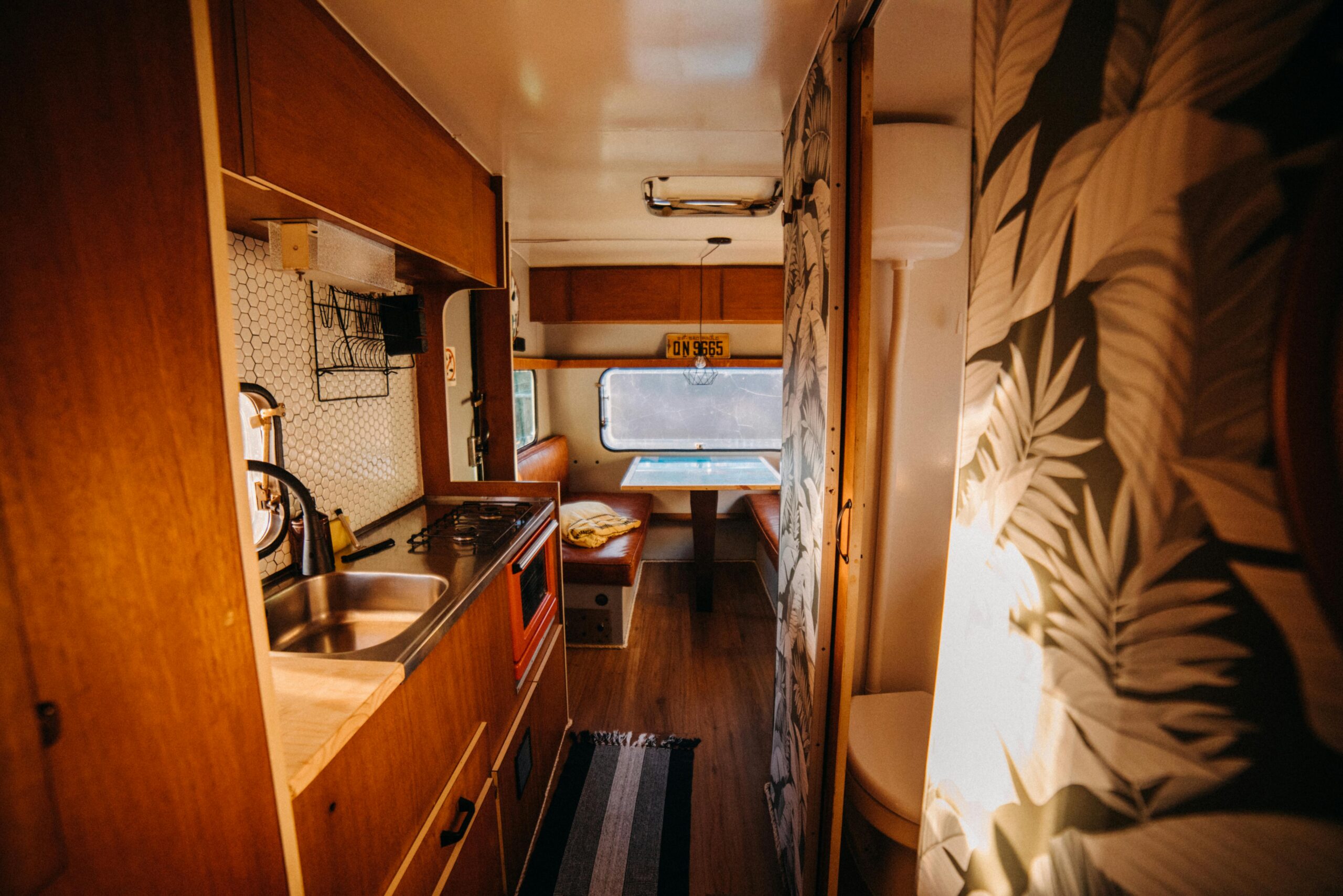 trailbound mobile rv service Warm and inviting camper kitchenette with retro decor, showcasing a cozy dining area and modern amenities.